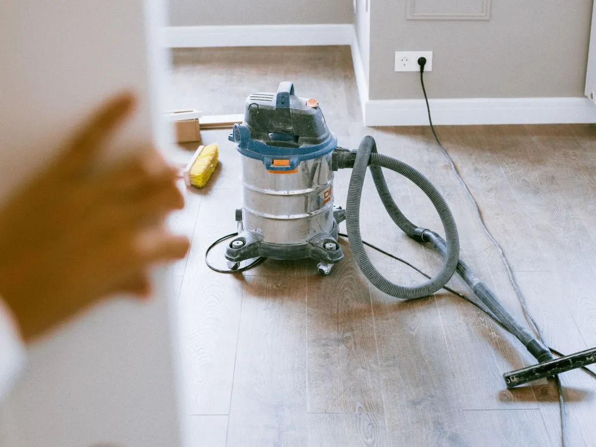 Shop vacuum on a wood floor in a freshly renovated room